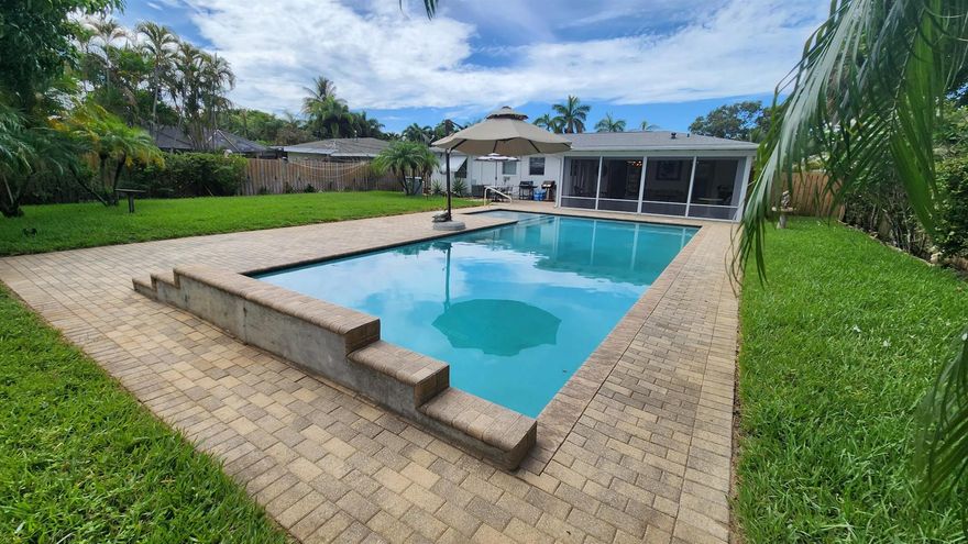 Impeccably maintained 2 BR / 2 BA home w nearly 1/4AC private oasis - heated pool w/shelf & bubblers, fenced yard, tons of room to entertain. NO HOA, pets welcome (w landlord approval)! Rent INCLUDES landscape, pool maintenance, & ADT! Large living area, granite kitchen, tile throughout, gas range, jetted bath, 2 massage chairs, large tiled screen patio. Surprising amount of storage. Circular driveway w plenty of parking, covered carport. Hurricane protection, monitored security system.  Walk to Avalon. Great location close to restaurants, shopping, golf, boating, fishing, diving, Palm Beach International Airport.