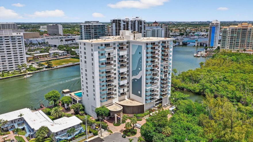 Experience luxury living at 777 Bayshore Drive, 1003, in Fort Lauderdale! This exquisite corner unit offers breathtaking views of the Intracoastal Waterway, the Atlantic Ocean, and the lush greenery of Bonnet State Park. With 3 spacious bedrooms and 2.5 baths, this home features an expansive living and dining area, perfect for relaxation and entertaining. The open-concept eat-in kitchen is a chef's dream, complete with a separate pantry and a stunning corner window that fills the space with natural light. Enjoy the beauty of new wood-look flooring throughout, a separate laundry room, terrific closet space, and impact glass for added security and peace of mind. The large balcony off the living room is a true highlight, featuring custom bar seating where you can relax and take in the view.