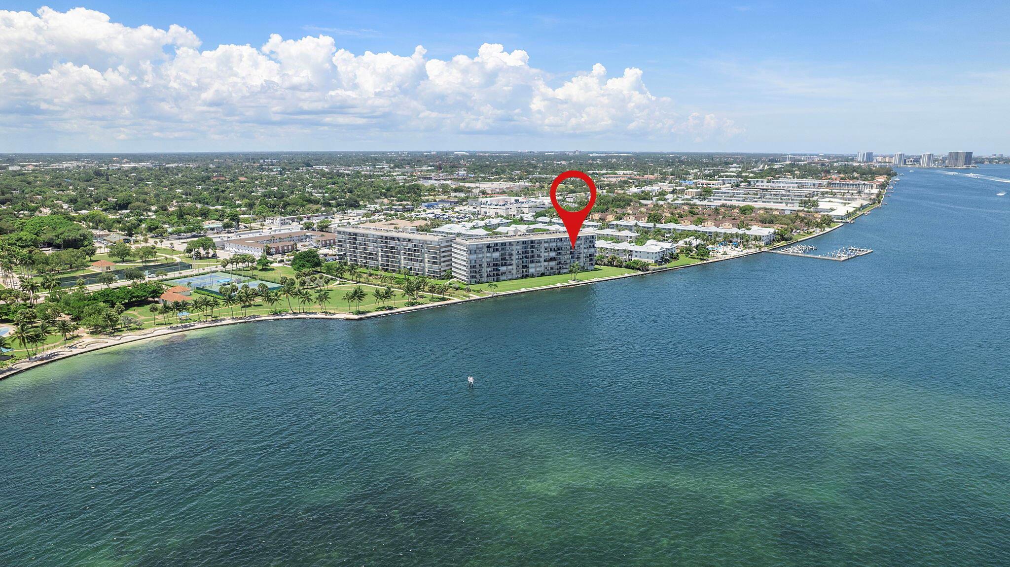 This home is designed for the water view. From the moment you step inside, you'll be greeted by an open floor plan that frames the sparkling water, setting the perfect stage for your dream renovation. Imagine the possibilities as you customize this space to your exact style and taste, all while enjoying the serene scenery from nearly angle. This 2-bed, 2-bath condo offers an exceptional lifestyle in a gated community. The oversized master bedroom features a huge walk-in closet, and the large balcony is perfect for entertaining the grandkids after a day spent at Kelsey Park. With a washer and dryer in the unit, convenience is at your fingertips. The building's recent milestone inspection is complete with no assessments and Fannie Mae approval, giving you the financial peace of mind to