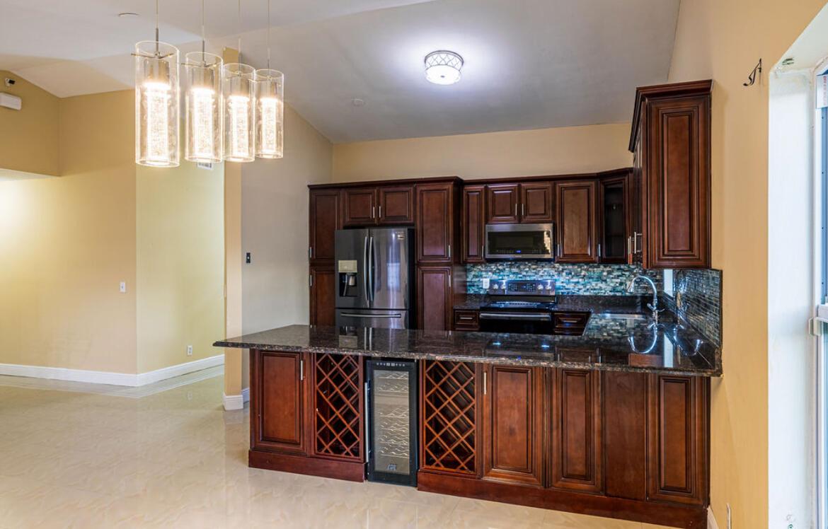 Welcome to this charming North Lauderdale home featuring a modern kitchen with granite countertops and sleek cabinetry. Enjoy the bonus Florida room perfect as a den, office, or playroom. The spacious backyard offers a private oasis with lush greenery and mature fruit trees, ideal for relaxing or entertaining. Don't miss this well maintained property in a great neighborhood schedule your showing today!