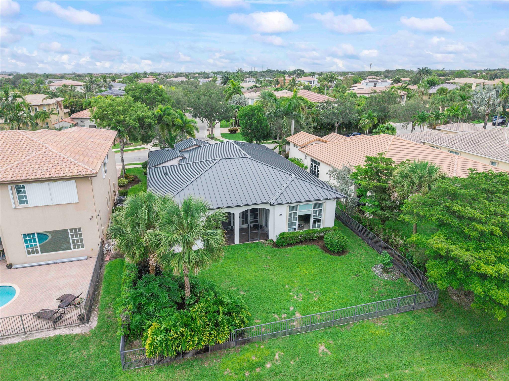 Heron Bay-The Glen, move in immediately, No HOA approval, Updated 5 bedrooms + sitting room/office/nursery on master bedroom extension,12 foot ceilings, 3 full bathrooms, extended Cardina model, guard-gated 24/7 security. New metal roof & full new metal gutters & drainpipes, marble & Porcelain flooring. Bright white chef’s kitchen w/white quartz counters & waterfall drops, stainless appliances, newer oven, microwave & dishwasher, updated white bathrooms w/quartz countertops, closets by design, LED lighting, white blinds. Mother-in-law or teen suite. Screened back & side patios. fully fenced back garden with 3 gates, room 4 pool, A+ schools, School bus stops at end of street. 2 resort-style clubhouses & pools, 2 gyms, waterpark, 13 tennis, & 6 pickleball cts, basketball, walking trails.