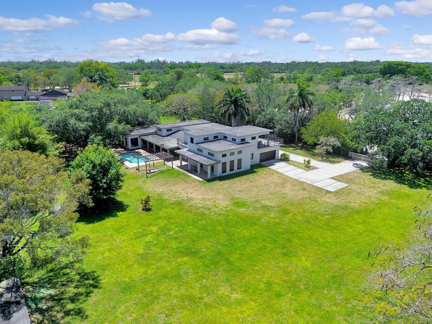 Welcome to your dream modern farmhouse nestled on 3 acres of picturesque land! This stunning four-bedroom, four-bathroom home offers an idyllic lifestyle with a stable, tennis court, kids' playground, and outdoor pool. Step inside to discover a spacious layout with high ceilings and slate floors throughout. The kitchen is a chef's delight with modern appliances and ample counter space. Retreat to the luxurious master suite, complete with a spa-like ensuite bathroom and walk-in closets. With its perfect blend of modern amenities and country charm, this property is the ultimate oasis for both relaxation and recreation.