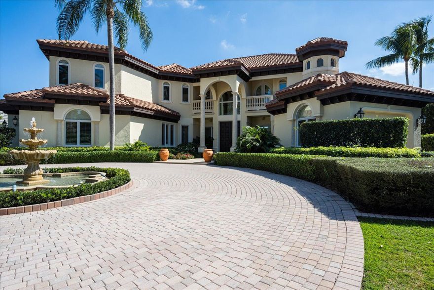 Located behind the private gates of the award winning Loxahatchee Club in Jupiter Florida, this gracious 5,727 sq ft, 4 bedroom, 4 bath, 2 half bath custom  estate is located on a half acre lake front lot with stunning panoramic views of the lake & Jack Nicklaus Signature golf course.  Upon your arrival, you are welcomed by a pavered circular driveway with 3-tier fountain and double solid wood front doors where you are immediately swept away by the panoramic water views through the wall of French doors in the 2 story living area. The adjacent formal dining room has views through a large window to a tranquil fountain. This home is perfect for entertaining with an open family room and a kitchen. One guest suite & office completes the first floor. A curved staircase or elevator takes you to the grande second floor master suite with its private balcony, luxurious spa bath and spacious walk in closets.  Two additional guest bedroom suites complete the second floor living space.  The outdoor lakefront area boasts a large pecky cypress accented lanai, sparkling pool and screened summer kitchen, perfect for the ultimate in Florida outdoor living.
