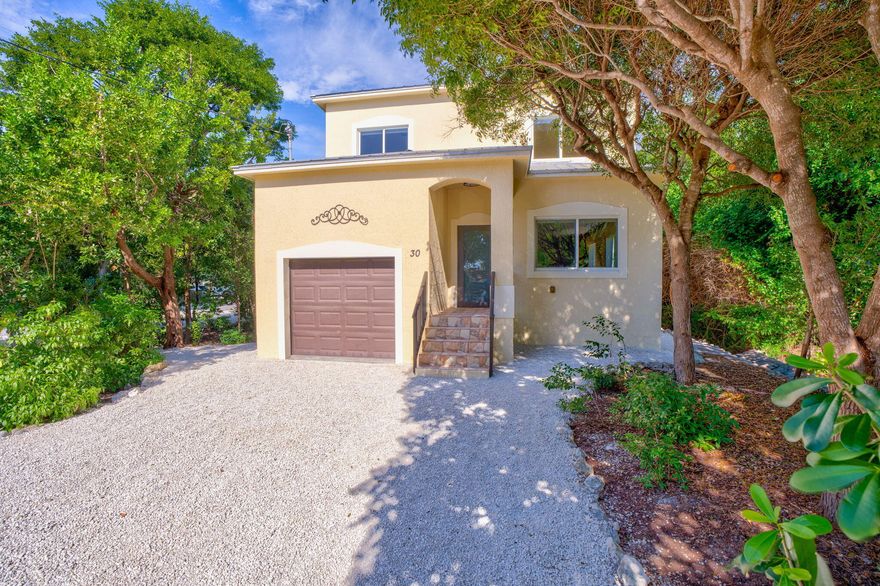 Are you dreaming of Key Largo and the laid-back beauty of the Florida Keys? Don't miss out on this wonderful opportunity! Step into this warm and welcoming 1,750 sq. ft. home with 3 bedrooms and 3 full baths surrounded by tress and privacy --perfect for relaxing or entertaining. Enjoy the flexible main-level bedroom option, easily making this a 4-bedroom, 3-bath retreat.   The master bath invites you to unwind in the Jacuzzi tub or separate shower, with a spacious walk-in closet. Ideally situated in the heart of Key Largo, you're just a short stroll or bike ride from friendly local restaurants, convenient shopping, pickleball courts, the community pool and park, and a variety of fun exercise classes. You'll love the thoughtful touches throughout, from the soaring ceilings and elegant crown molding to the custom blinds and cooling ceiling fans. The 50-gallon water heater, dual A/C units, and gorgeous porcelain tiles add both comfort and style to every corner.


Just minutes away, Key Largo Harbor invites you to explore its lively marina and charming resorts. Enjoy glass-bottom boat adventures, friendly local dive shops, exciting fishing charters, and delicious meals at vibrant waterfront restaurants. You might even catch a glimpse of the world-famous African Queen steamboata beloved part of film history from the 1951 classic starring Humphrey Bogart and Katherine Hepburn!


This cheerful home is built for peace of mind, with sturdy CBS construction, a long-lasting metal roof, and impact-resistant doors and windows. The laundry is thoughtfully located on the main floor, and the garage provides plenty of extra storage for your Keys adventures.