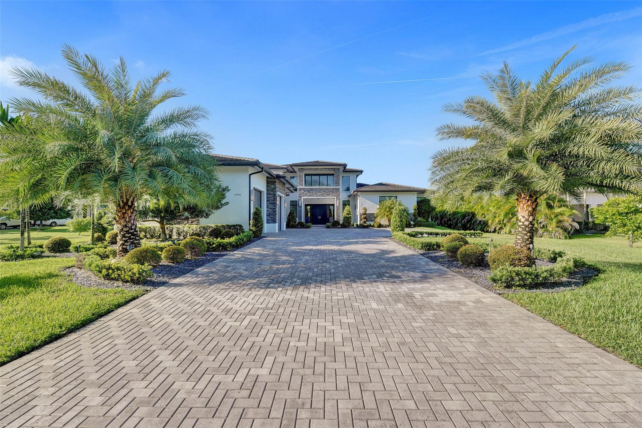 Experience luxury living in this expansive 5BR/5BA home with over 7,200 sq ft on a quiet cul-de-sac. Soaring volume ceilings and large windows fill the interiors with natural light, creating a bright and welcoming atmosphere. The oversized chef’s kitchen features a generous island and flows seamlessly to a spacious covered patio with a summer kitchen, ideal for hosting family gatherings or entertaining friends year-round. Relax in the private primary suite, complete with spa-like bath, dual vanities, and ample closet space. Private basketball court, oversized 3-car garage, and multiple versatile living areas perfect for work, play, or relaxation. This home offers the perfect combination of space, comfort, and style, conveniently located near shopping, dining, parks, and top-rated schools.
