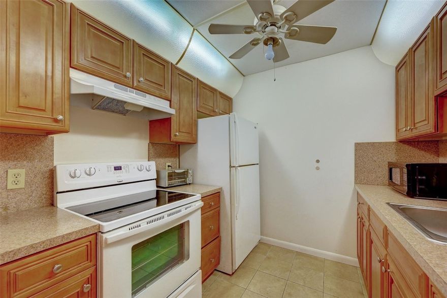 REDUCED TO SELL -1 bed 1.5 baths, garden view, tile floors, updated kitchen and appliances, being on the ground floor eliminates the need to climb stairs or wait for an elevator, making it easily accessible. 1 assigned parking space but plenty of guest parking. The laundry room is located next to the unit, additional storage in the patio, Glass door/walk in shower in the bathroom. 55+ community, lots of activities, clubs and amenities: Golf, pools, gyms, tennis, billiards,  clubhouse, movies and shows. Security patrols, courtesy transportation and much more.Water, cable Tv, internet, roof, building exterior, maintenance included. Maintenance fee to New Hampton IV $430/month and $255/monthly  to CVP- Total maintenance $685/ month. NO RENTAL RESTRICTIONS- 650 MINIMUM CREDIT SCORE REQUIRED.