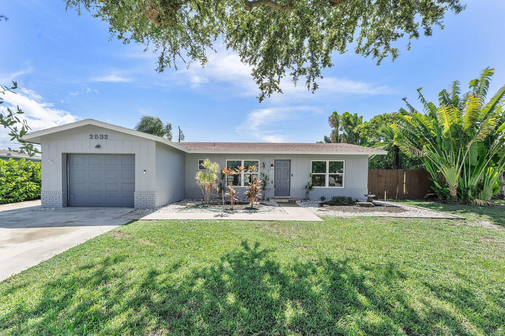 Embrace the beauty of this inspiring 3-bedroom, 2-bathroom single-family home with a welcoming 1-car garage and a refreshing pool. Located in a desirable neighborhood, just minutes away from the beach and vibrant shopping, this home invites you to live your best life. The open floor plan, with its elegant tile flooring, creates a seamless flow throughout the living areas, where a charming brick accent wall adds character and warmth.Step outside and immerse yourself in your private backyard oasis, where a tranquil pool and peaceful koi pond beckon you to relax amidst lush tropical landscaping that feeds the soul. Enjoy mornings in the enclosed Florida room, a perfect space to reflect and rejuvenate while gazing at the beauty of your outdoor sanctuary.