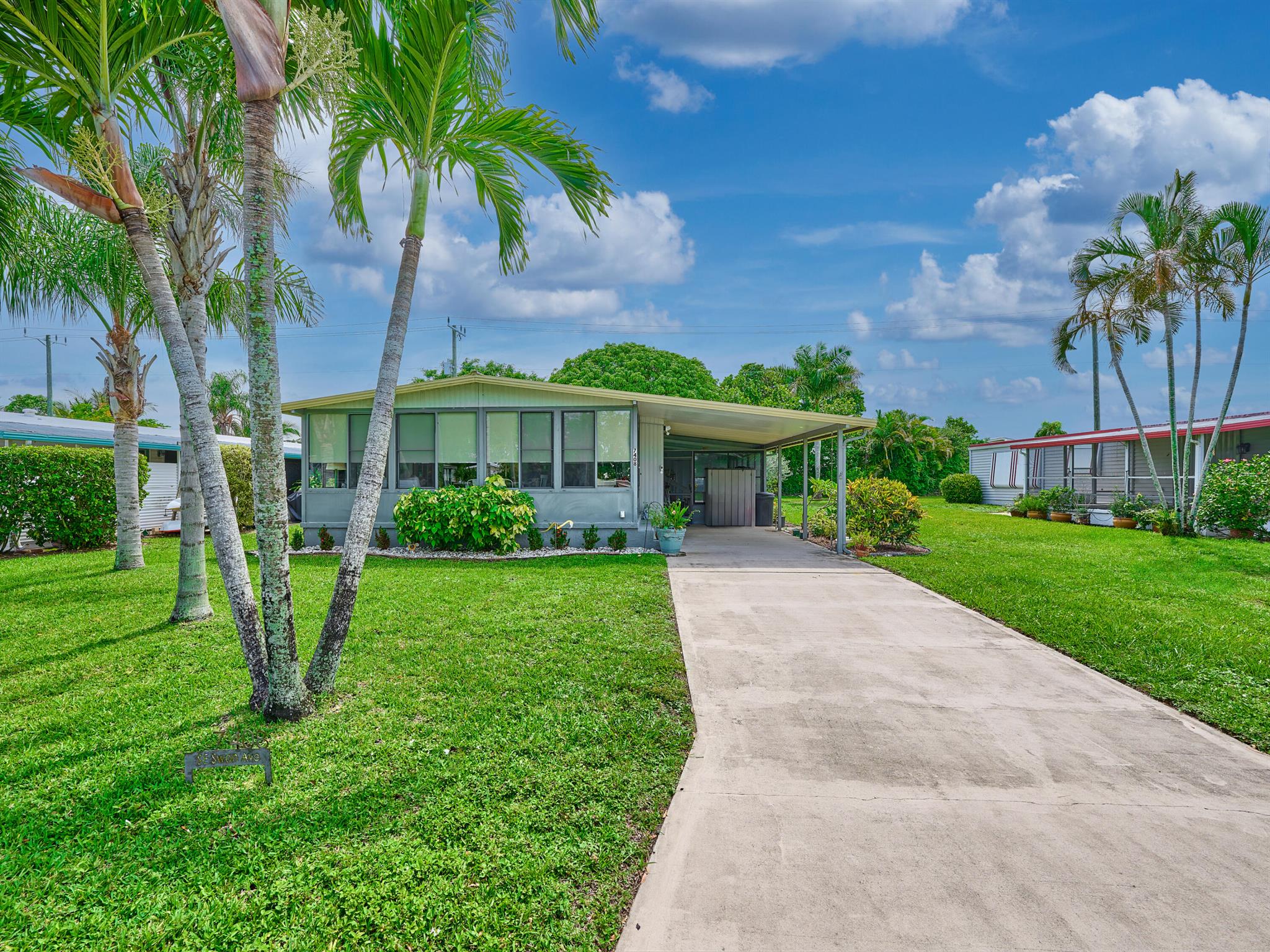 3 Bedrm/ 2 Bath Manuf home in Ridgeway, all ages community in Hobe Sound. Great Kitchen w Granite counters, updated backsplash, undermount sink, lighting & modernized cabinets. The LR is lovely & leads out thru French doors to glassed in front FL rm. The dining area is off the LR. Attractive trim work lines the Hallway w an open pantry, linen closet & Laundry. The primary bedrm is so inviting w updated Bath, walk-in closet & slider out to the back deck w new Trex decking. This is an oasis in the fully fenced backyard. Bedroom 2 & 3 each have twin beds awaiting friends & family. There is also a side Lanai w fresh screens, vinyl windows & new paint. 2006 Aluminum roof, A/C 2015. Ridgeway is mins to Ocean beaches, ICW Boat ramp, shopping & restaurants. You own the land - all pets welcome