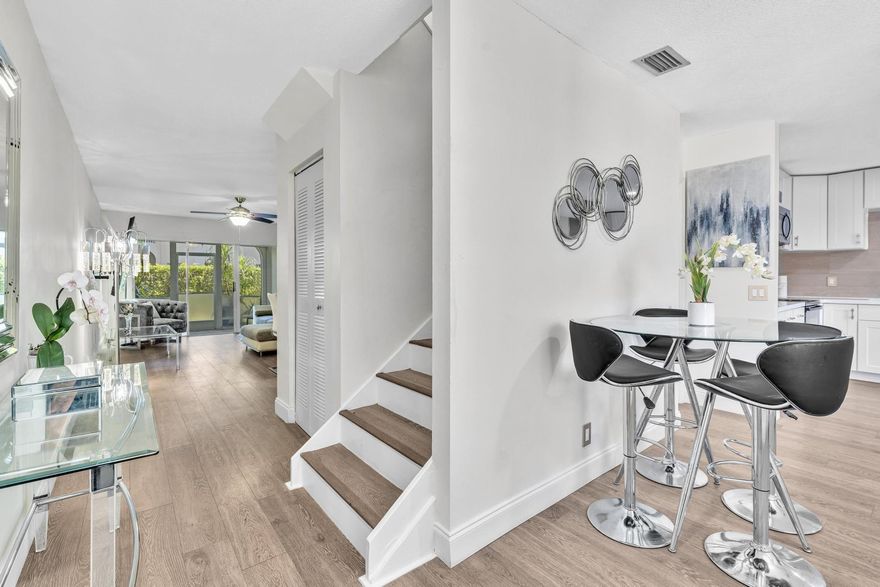 This cozy 2-bed, 2.5-bath, 2-story townhome in the highly sought-after Boca Pointe community.The kitchen features luxury vinyl flooring, white cabinetry with gold accent hardware, a gold farmhouse sink, light beige tile backsplash, & extra pantry space. Appliances include a newer stove & refrigerator. The stackable washer & dryer are conveniently located between the 2 primary bedrooms, 2 skylights bring in natural light. The primary bathroom offers beige natural floor-to-ceiling tile & dual vanity sinks with floating natural wood grain cabinet. The guest full bath includes a shower & tub with floor-to-ceiling tile & gold hardware accents. Relax outside on your screened patio. AC 2023, Pets welcome with restrictions. Rent right away. Your assigned parking spot is located directly in front.