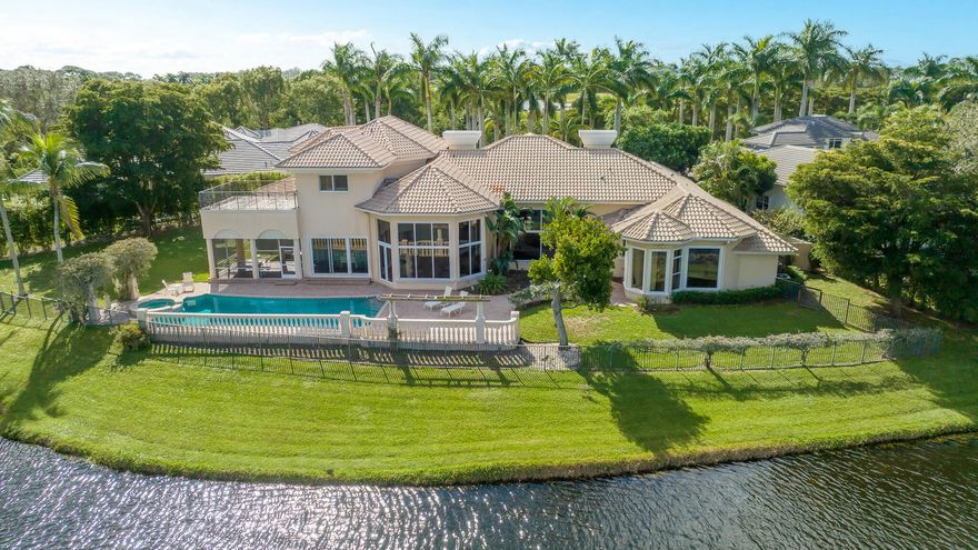 Incredible estate home on over 1/2 acre with sweeping lake and golf course views.
