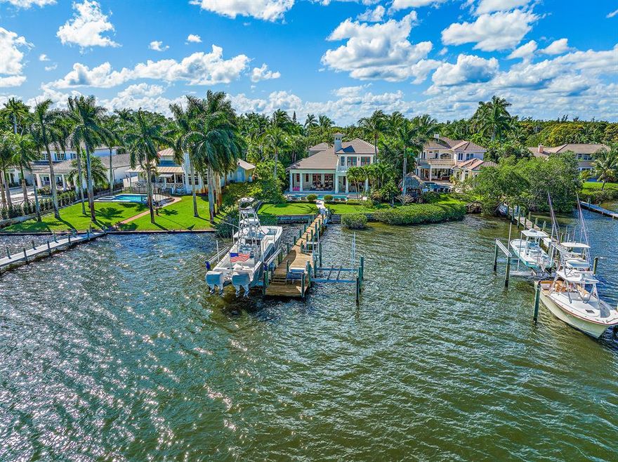 This spectacular Riverfront Estate offers wide panoramic views of the Loxahatchee River. Surrounded by nearly one acre of tropical lush landscaping, this British West Indies CBS home offers outstanding finishes throughout the ~4,600 s.f. living area. The home was extensively renovated in 2014 with no detail overlooked. Offering an open floor plan with a chef's kitchen, large swimming pool & spa, ample outdoor entertaining space, outdoor kitchen, built-in pizza oven, private dock with two boat lifts (12k & 24K), a detached guest house, 4 car garage, gated entry, whole house generator, first floor master bedroom, new roof (2015), new windows & doors (2012) and much more. This home comes with all the luxuries you would expect and offers resort style living! Selling furnished, with exceptions.