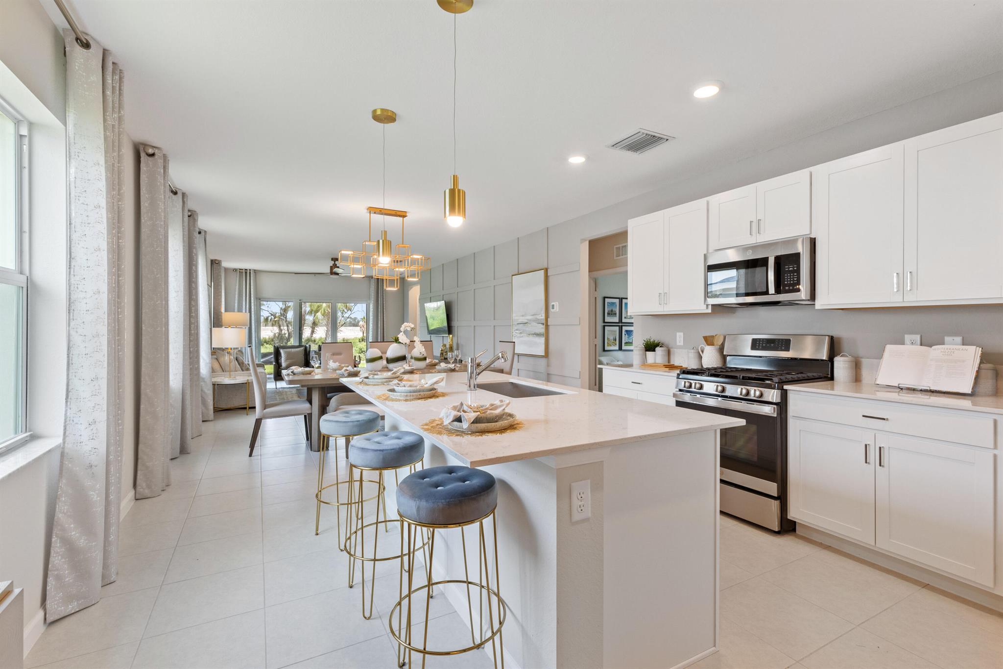 This single-story home features a smart layout that prioritizes ease of living. Down by the foyer is an open-plan design shared by the kitchen with a center island, dining room and family room, which extends out to the covered lanai. On the opposite side of the home are two bedrooms to provide a restful retreat and a den well-suited for as a private office. At the front is a versatile two-car garage.Photos are for illustrative purposes only.