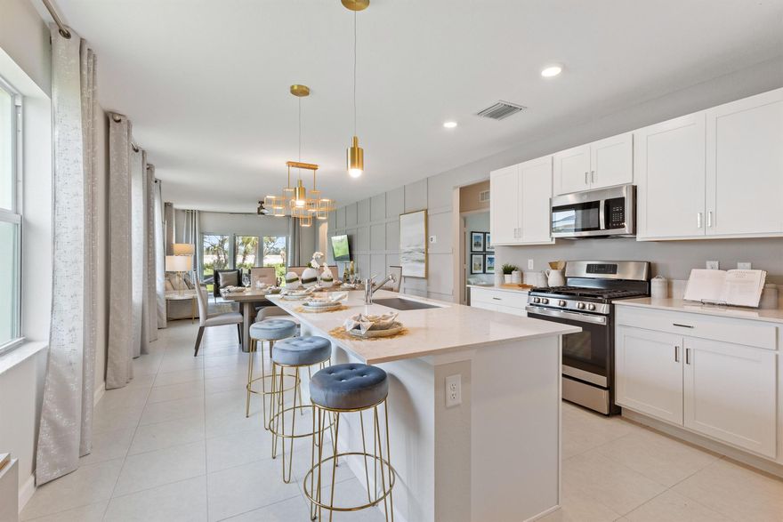 This single-story home features a smart layout that prioritizes ease of living. Down by the foyer is an open-plan design shared by the kitchen with a center island, dining room and family room, which extends out to the covered lanai. On the opposite side of the home are two bedrooms to provide a restful retreat and a den well-suited for as a private office. At the front is a versatile two-car garage.Photos are for illustrative purposes only.