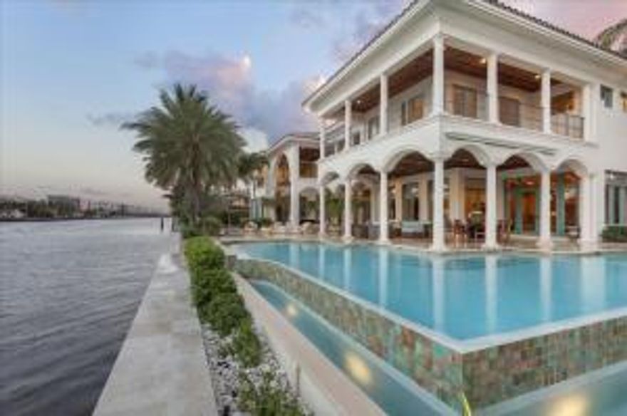 Meticulously designed, this Palm Beach-inspired Estate located on a Direct Intracoastal Point Lot with 272' of waterfrontage is a yachtsman's paradise and offers resort living at it's best.  This stately residence comprises a total 12,724 +- square feet with 5 bedrooms, 6 full and 2 half baths.  From the majestic mahogany double door entry, myriad special features include the exceptional millwork, impact-glass windows and exterior doors, energy-efficient multi-zone heating/cooling with four new units and hydraulic elevator.  Radiating off the foyer, the bright window-walled living spaces flow room to room and from inside to the outdoors.  This "smart house" is equipped with a Lutron system and one of many recent updates includes a Crestron system for surround-sound.****SEE MORE****