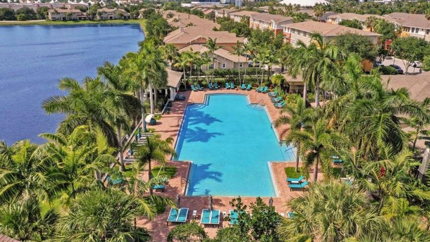 This STUNNING 2 bedroom, 2 bath townhome boasts chic & stylish living. newer kitchen,granite, open floor plan, hurricane impact windows, 10/2025 AC unit, and 2024 water heater. Enjoy high ceilings, a trmendous amount of natural light, a spacious 2-car garage, a separate laundry room with additional storage, and a walk-in closet in the master suite.  24/7 manned gate, an olympic size pool, barbecue area, clubhouse, aerobics room, fitness Center and a one mile Trail around the pond and neighborhood. The location is unbeatable, within walking distance to shopping, Wholefoods, dining, and just minutes from beaches, major highways, downtown, and the airport. HOA includes resort style amenities, water, internet, and basic cable.