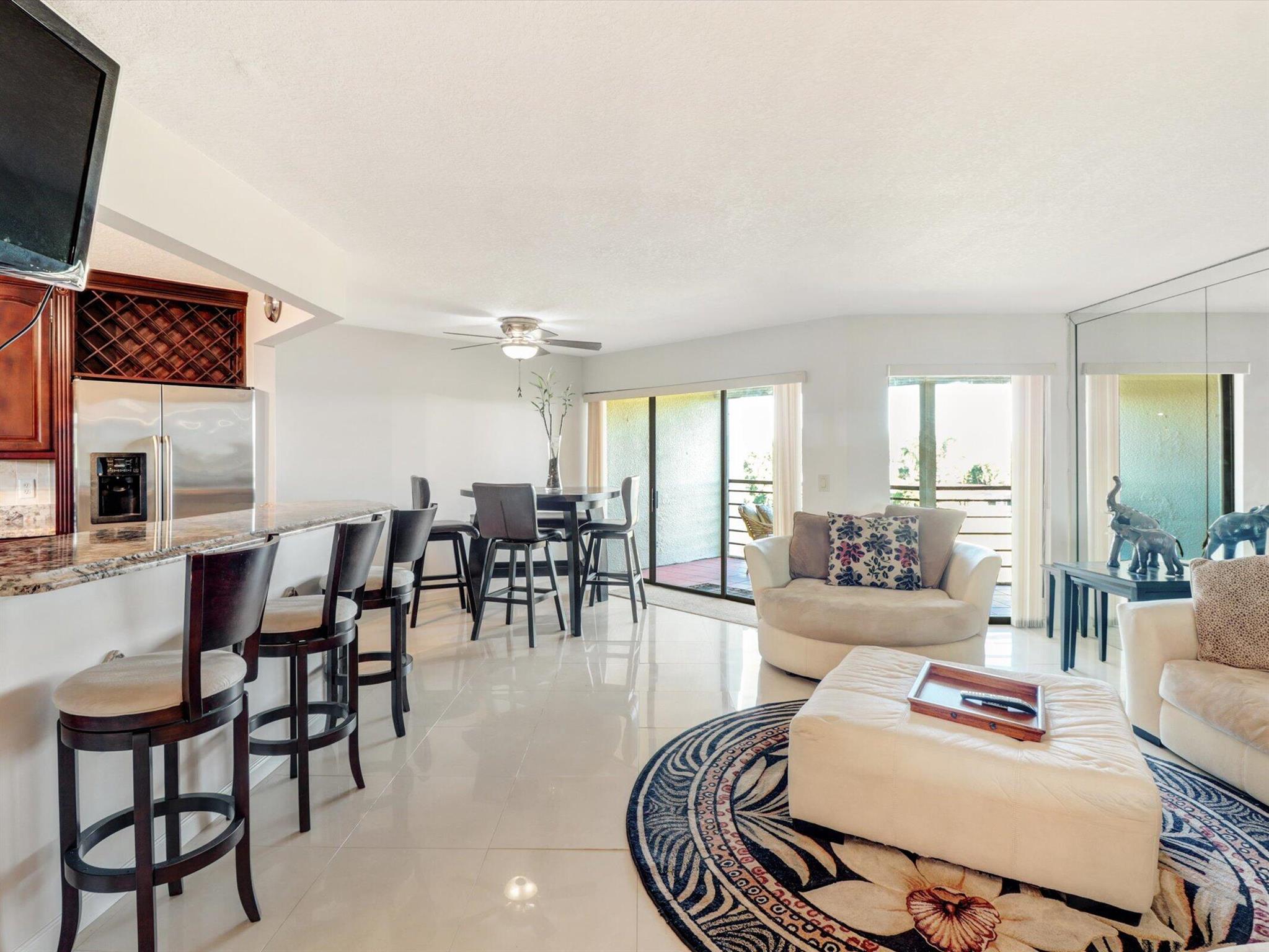 Light, bright, and spacious 2/2 corner penthouse (4th floor) unit in beautiful Camino Real Village. This unit has been freshly painted and features an updated kitchen with wood cabinets, granite countertops, and stainless steel appliances. Both bathrooms are also updated, and master bath features a steam shower and a jacuzzi tub. Newer a/c and hot water heater and no popcorn on the ceilings. Master closet is very large and has custom closet organizers. Washer/dryer inside the unit. Entry to the screened patio area from both the living area and master bedroom. Lovely private garden view from the patio. Camino Real Village is a great manned gated community centrally located to great restaurants and shops. Four community pools, tennis, & a small fitness room just steps from the apartment.