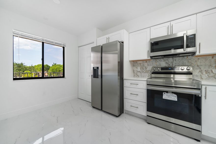 Meticulously crafted, beautifully and newly renovated 2/2 plus den and Florida room. 30'' white tile floors, white wood cabinets and quartz counters in kitchens and baths. All new appliances.Spacious, eat-in kitchen. No popcorn on ceilings. Panoramic lake view. Laundry inside. New washer and dryer.  The only missing item is you. Huntington Pointe is a 55+ community with a 50,000 square foot clubhouse. 600 seat theater with live entertainment and movies year 'round. Card rooms, billiard room, ping pong room, gym, indoor pool, 4 outdoor pools, bocce, tennis, pickleball, numerous clubs and organized activities, and cafe that's open for breakfast and lunch every day.