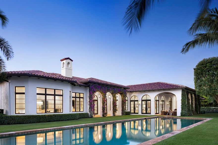 Proudly introducing Arabella. Elevated to the highest level of luxury and comfort, this remarkable Cypress Island estate has been totally made new and enhanced inside and out; offered with bespoke, custom furnishings curated by world-renowned Marc-Michaels Interior Design. Situated on a waterfront lot in the prestigious Palm Beach Polo Golf and Country Club, the updated and luxurious single-story design features almost 6,000 sq ft of living space, 4 bedrooms, 6 full baths, one half bath, and a 3-car garage. The modern, open floor plan includes a state-of-the-art chef's kitchen with Wolf appliances, a glass enclosed walk-in wine cellar with adjacent formal dining room, and a hand-built fireplace centering the living room. Each of the 3 VIP self-contained guest suites are more than spacious: with private bathrooms, kitted-out closets and designer furnishings. The owners wing includes private entry onto an outdoor loggia, his and her baths, and ample dressing areas. The outdoor living areas are superb for entertaining, featuring lush and mature landscaping surrounding the oversized saltwater swimming pool, two separate loggias, a fully equipped summer kitchen, attached cabana full bath, and dramatic water views. For your peace of mind, all home systems have been updated to reflect the most modern technology and connectivity, completing this classic estate, refreshed and renewed for today and tomorrow.