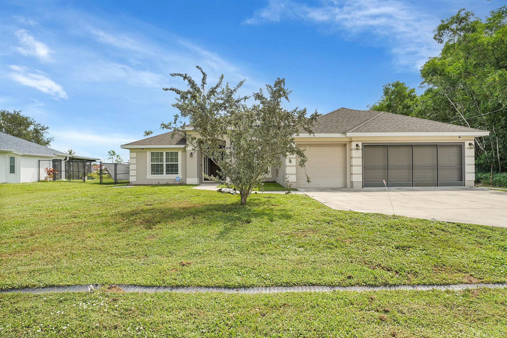 Built in 2018, this 4BR/3BA CBS home offers 2,266 sq ft with a 3‑car garage on a quarter‑acre lot backing a peaceful reservoir. The split plan features a granite kitchen with stainless appliances and breakfast bar, open living/dining, and a spacious primary suite with dual vanities, soaking tub, and walk‑in shower. Benefit from a low cost electric bill with a paid off solar system! Enjoy sunsets from the screened lanai and a fully fenced yard. Minutes to PGA Golf, River Park Marina, shopping, dining, and Hutchinson Island beaches, with easy access to I‑95 and the Turnpike.