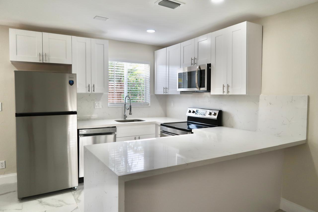 Now available for rapid approval, Brand-new, completely renovated 2 bed, 2 bath home in a desirable duplex setting. This light-filled residence features a modern kitchen with stainless steel appliances, sleek cabinetry, and open dining space. Enjoy a fully fenced yard for complete privacy, a spacious backyard, and direct access to a sparkling pool. Additional highlights include tile flooring throughout, a new air-conditioning system, laundry, and 4 dedicated parking spaces. No HOA. Ideally located just minutes from the beach, Las Olas, Premier dining, parks, and major highways. Move-in ready!
