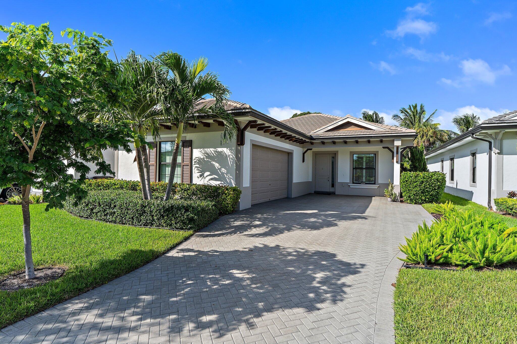Welcome to this beautifully furnished and thoughtfully appointed home in the exclusive community of Banyan Cay. This newer construction 2 bedroom plus den, 3 bathroom residence in the heart of West Palm Beach offers the perfect blend of style, comfort, and convenience.Featuring many beautiful upgrades throughout like wood look tile flooring, plantation shutters, built out closets, an upgraded patio with electric awning and the Egg BBQ. This gorgeous home offers a formal dining room and an open floor plan kitchen as the perfect space to entertain and cook. The adjoining large family room opens up to a private backyard for plenty of room to entertain, play and lounge. Solar panels ensure impressively low energy costs, making this home as efficient as it is beautiful.Banyan Cay is