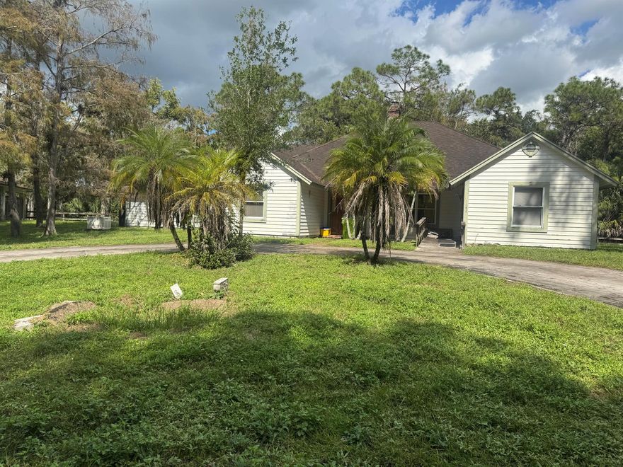 Motivated seller! This Loxahatchee Groves fixer-upper sits on 5 acres of beautiful, private land  perfect for investors or a family looking to add their own personal touch. The property offers endless potential with plenty of room to expand, build a barn, or create your dream outdoor space. Enjoy peaceful country living with no HOA, a gated entrance, and ample room for boats, RVs, or horses. Bring your vision and make this property your own! Opportunities like this don't come often in Loxahatchee Groves!