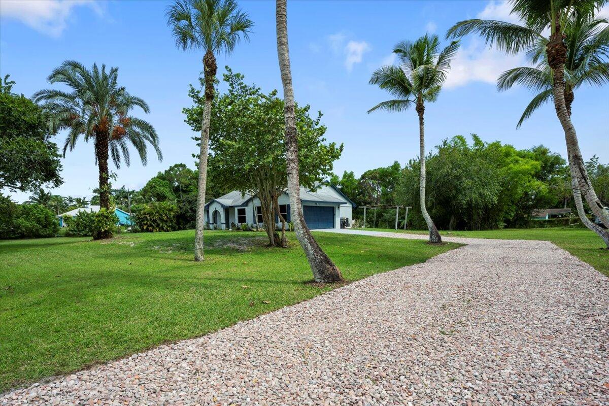 Welcome to this beautifully updated 4-bedroom, 2-bath home in the heart of Loxahatchee, offering comfort, style, and peace of mind with numerous recent upgrades. Inside, you'll find a brand-new kitchen featuring stainless steel appliances, crisp white shaker cabinets, and modern finishes. Both bathrooms have been tastefully renovated, and new luxury vinyl wood flooring flows seamlessly throughout the home.Practical updates include a newer A/C system, 2021 roof, newer hot water heater, new septic system, and a new well pump--ensuring this home is truly move-in ready.
