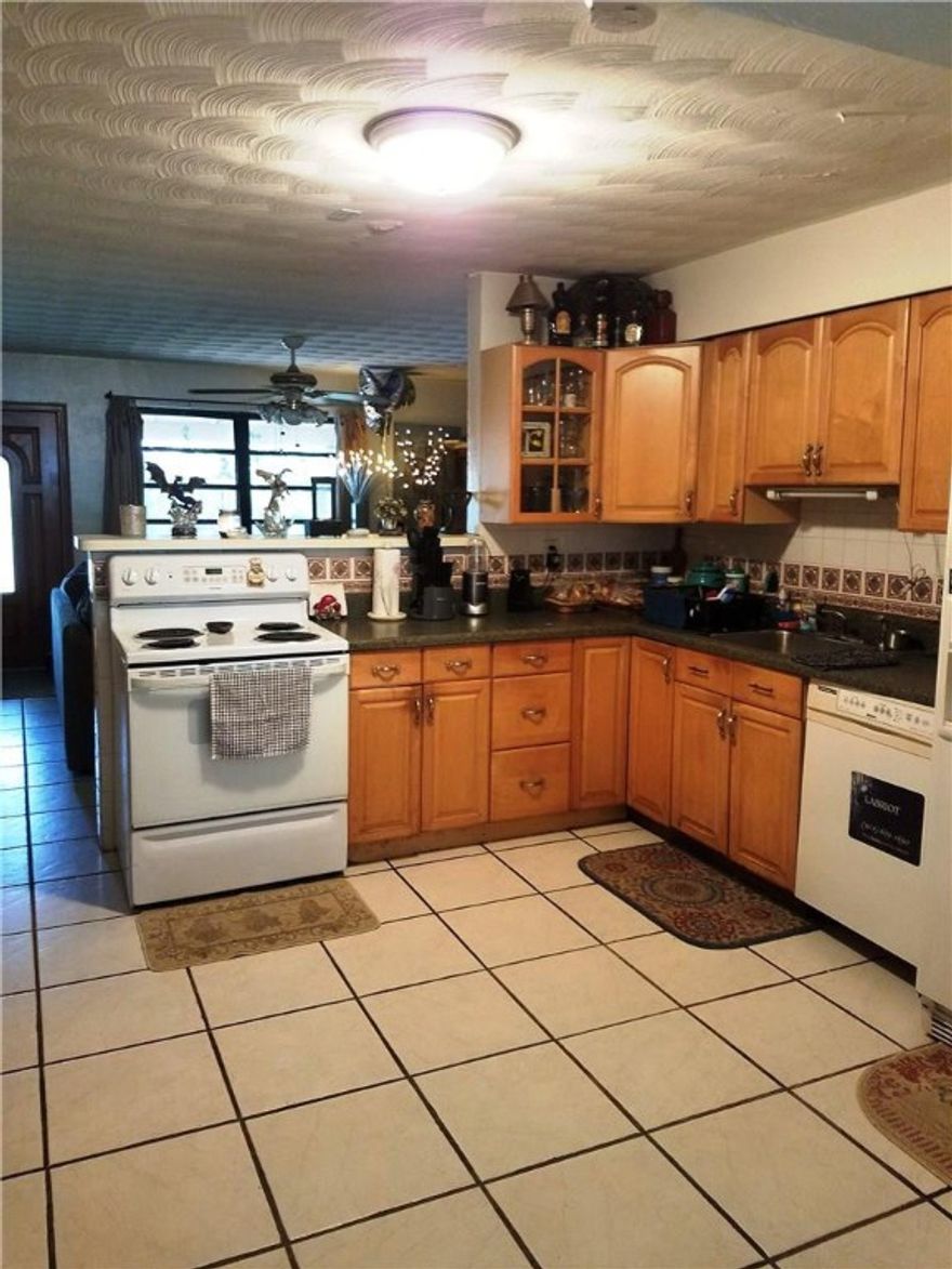 Great Well Maintained Home PLUS under contract now for All New Impact Windows and Doors !  3/2 with 4th bedroom adjacent to master bath. New Electric thruout, A/C in great condition, new shower pan in master shower, newer kitchen w/extra cabinets, lovely large back yard w/ screened patio,and additional detached thatched roofed wooded patio and storage in back yard.Enjoy the Large front yard w/ Shade trees from the front porch.Long term tenant would love to stay, lease up November 30, 2017.
