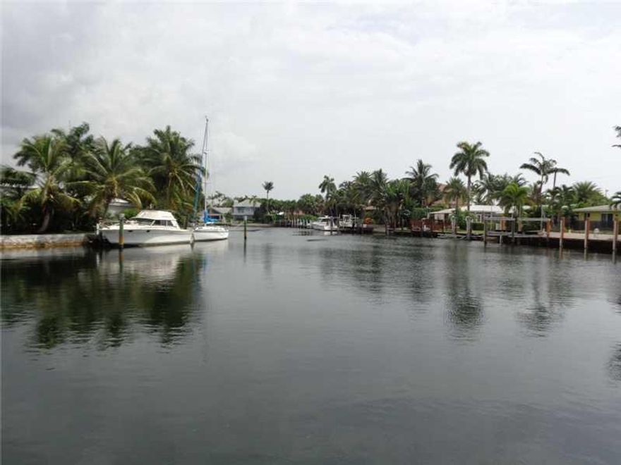Fantastic water views down the Cap Knight Bayou canal from this perfectly located 4 bedroom, 2 1/2 bath pool home in Lighthouse Point. Open and bright with large living areas and split bedroom plan. Kitchen, breakfast area, living room and dining room all  open to huge screened patio with gorgeous water and sparkling pool views.  Lots of closet space and large laundry room. Quiet cul-de-sac street. Great water, great home and great location!
