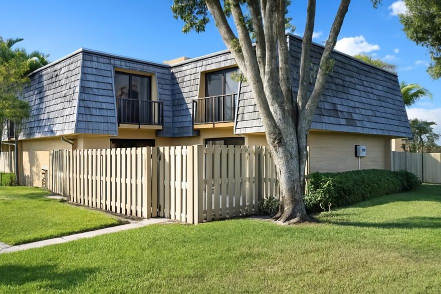 Discover the appeal of this inviting 2-bed, 2-bath townhome, thoughtfully designed inside and out. The exterior offers a beautifully kept shared green space, private patio, open balconies, and easy-to-use accordion shutters. Step inside to a large living area enhanced with custom lighting, built-in shelving, a decorative fireplace, and durable ceramic tile flooring. The kitchen flows directly into the dining space and is complemented by a full downstairs bath and extra storage. Upstairs, you'll find a spacious primary bedroom along with a generous second bedroom featuring custom mirrored closet doors and its own balcony access. The shared bathroom includes double sinks, and the home is equipped with a gas hot water heater for added efficiency. This townhome blends comfort & charm.