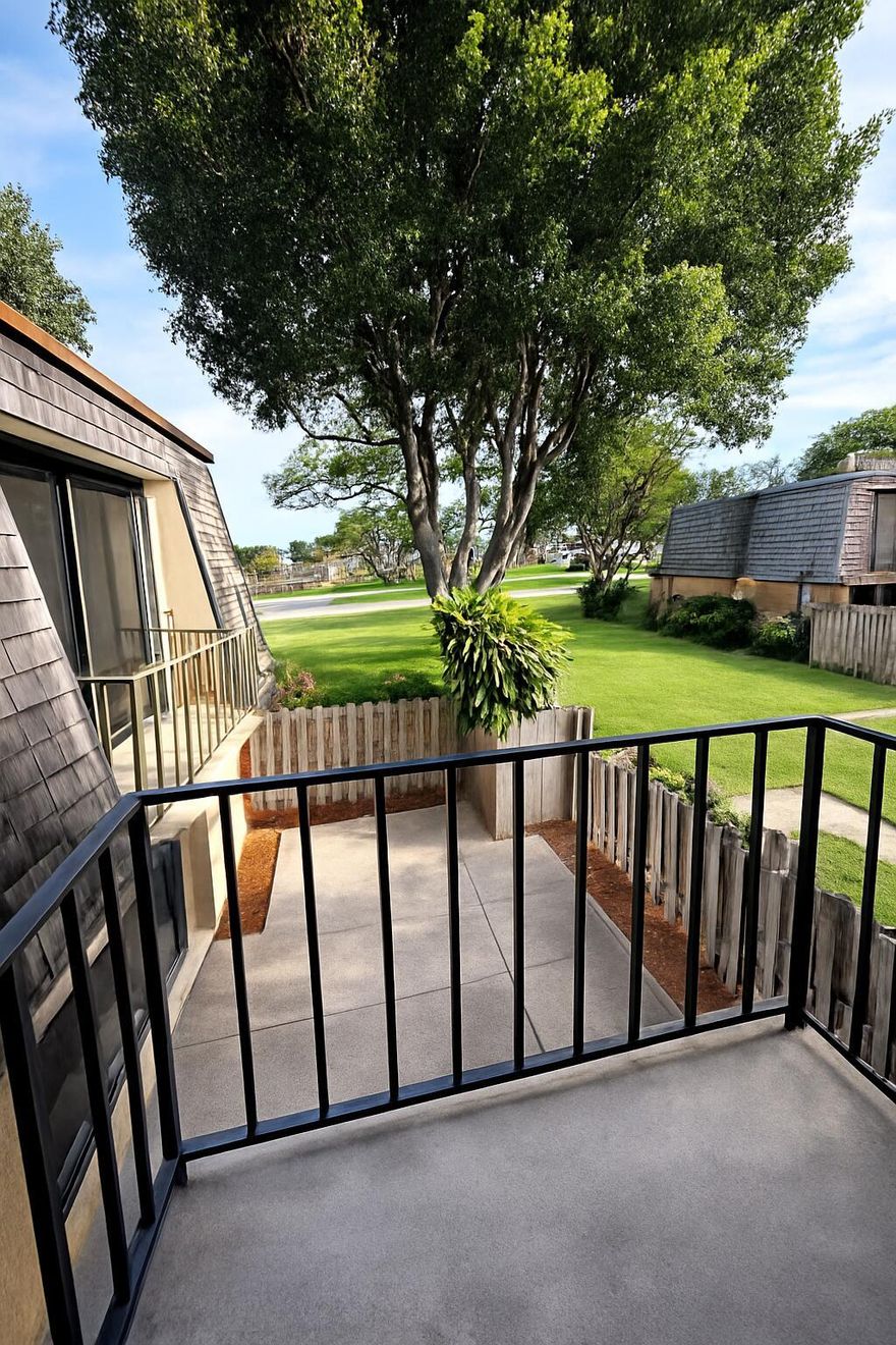 Discover the appeal of this inviting 2-bed, 2-bath townhome, thoughtfully designed inside and out. The exterior offers a beautifully kept shared green space, private patio, open balconies, and easy-to-use accordion shutters. Step inside to a large living area enhanced with custom lighting, built-in shelving, a decorative fireplace, and durable ceramic tile flooring. The kitchen flows directly into the dining space and is complemented by a full downstairs bath and extra storage. Upstairs, you'll find a spacious primary bedroom along with a generous second bedroom featuring custom mirrored closet doors and its own balcony access. The shared bathroom includes double sinks, and the home is equipped with a gas hot water heater for added efficiency. This townhome blends comfort & charm.