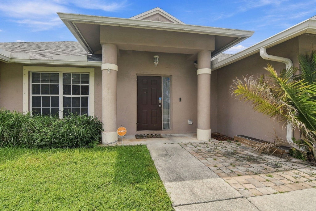 Photo of 1734 SW Capehart Avenue, Port Saint Lucie, FL 34953 (MLS # B26078481)