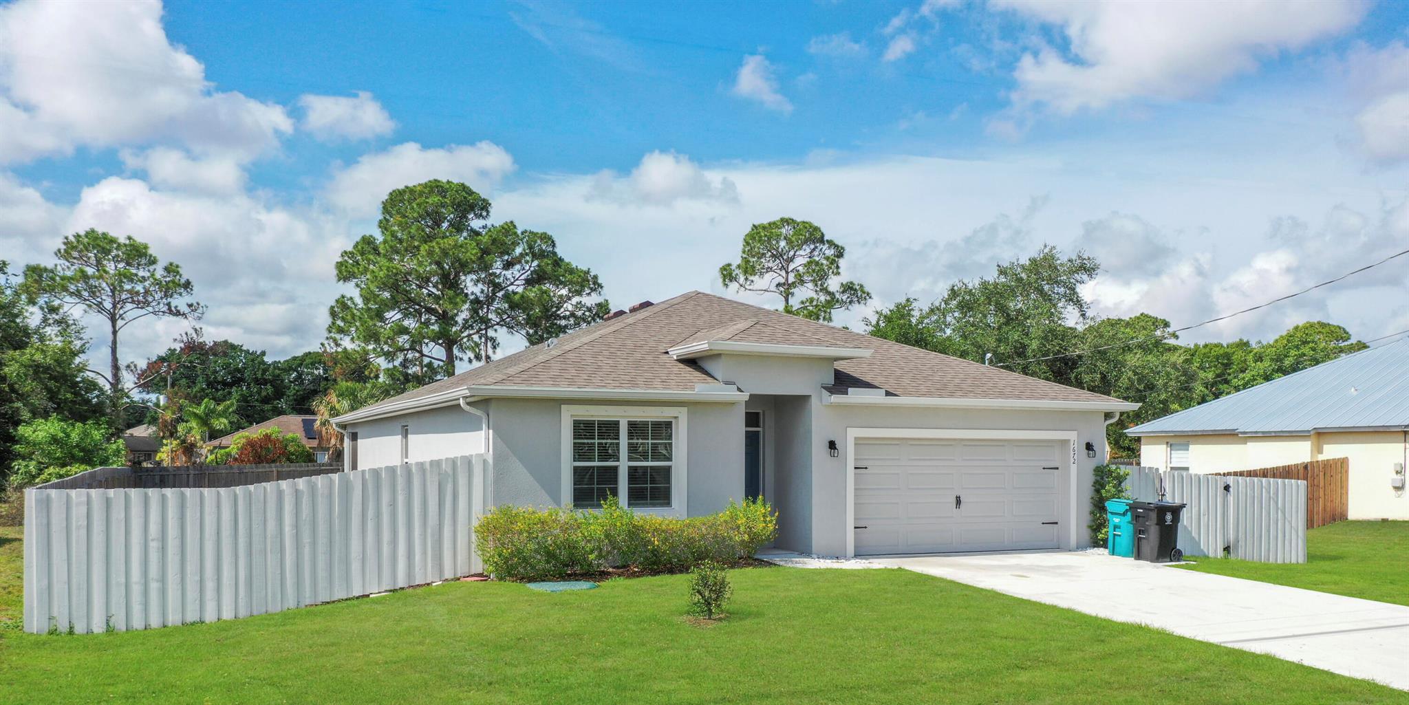Welcome to this beautiful 4-bedroom, 2-bathroom, 2-car garage home located in a highly desirable area of Port St. Lucie! This spacious and well-maintained property offers a split floor plan, tile and laminate flooring throughout (no carpet!), and an open-concept living and dining area perfect for entertaining. The modern kitchen features stainless steel appliances and plenty of cabinet space. Enjoy the comfort of a large master suite with a walk-in closet and double sink vanity. The fully fenced backyard is ideal for relaxing or family gatherings. Conveniently located near schools, shopping, restaurants, and major highways. Ready for immediate occupancy--don't miss this opportunity!