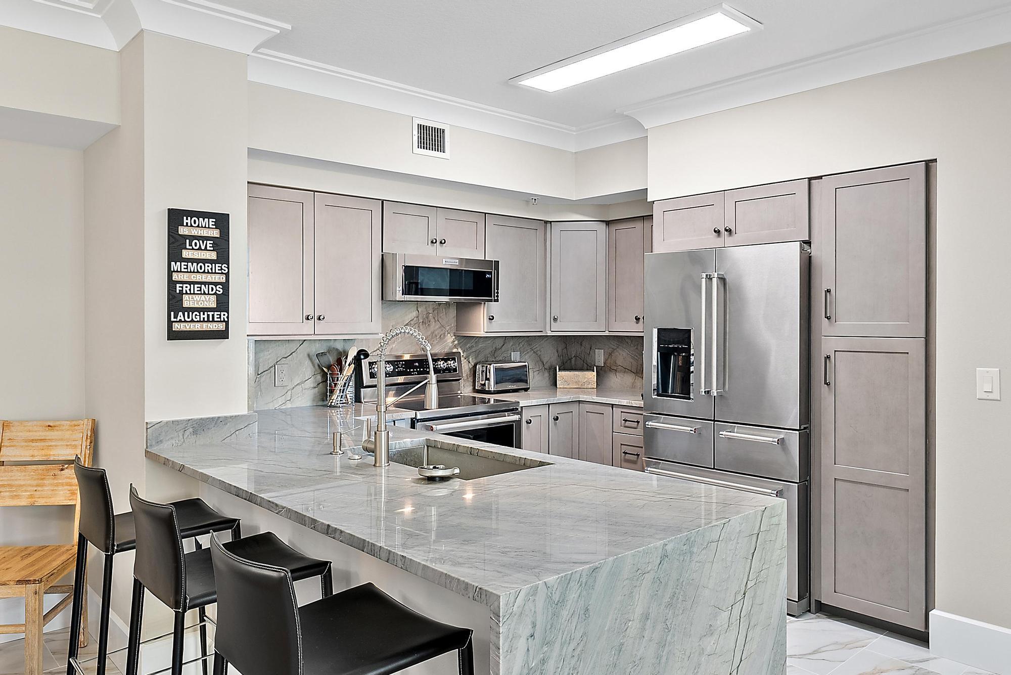 Experience the best of waterfront living in this beautifully updated corner unit located in the highly desirable Marina Village community. This spacious condo features (2) ensuites, (2) side-by-side covered garage parking spaces, perfect for the executive or seasonal lifestyle. Just steps from the marina & (2) popular seafood & bar waterfront restaurants. Location offers unbeatable convenience & coastal charm. 2024/25 renovations throughout the unit, ceramic 36x16 tiled flooring runs through the main living areas, while the bedrms offer LBT laminate flooring, thick baseboards, trim & crown molding add a high-end feel, custom ceiling fans & lighting fixtures, the kitchen is designed for both style & function, w/quartz countertops w/waterfall edge, custom cabinetry & matching SS appliances.
