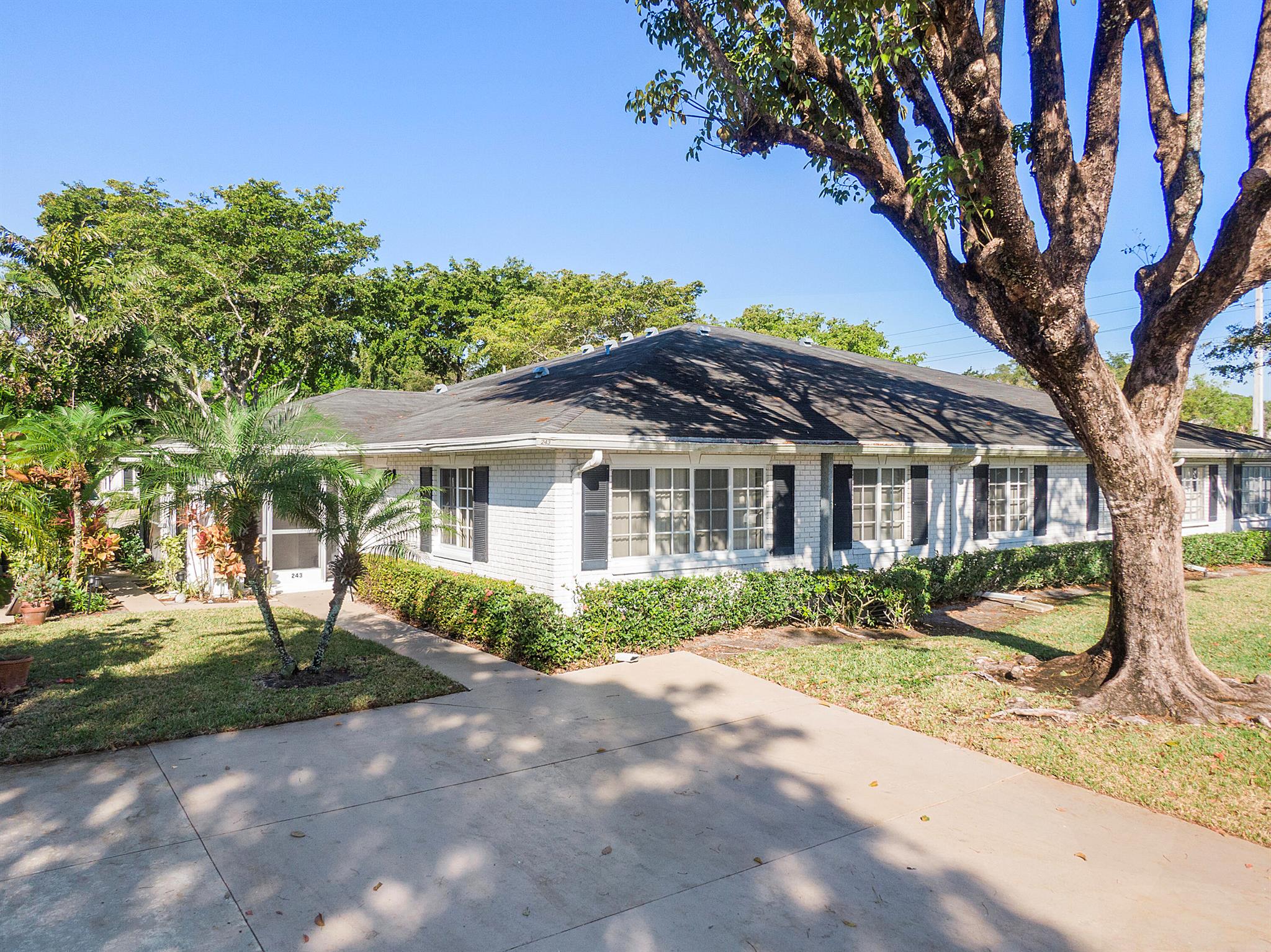 This is such a warm and inviting 2 bedroom, 2 bath spacious villa. White-brick surrounded by Palms, Shade Trees and Lush Tropical Setting. Brand new stainless steel appliances, Quartzite countertops. Ceramic tile floors. Barn door hides a custom oversize laundry room area complete with front load stackable washer and dryer. LED Lit mirrors in bathrooms plus industrial glass sliders. Completely Remodeled. Air conditioner install in 2019. Hurricane windows throughout the unit. This gem has hurricane proof windows. Screened Patio. You can BBQ At Villa! The community has Shuffleboard, Bocci, Fitness Center,3 Pools, Tennis courts, Pickle Ball and Club House. Water, sewer, cable and insurance on the building. Minutes to shop & dinning!