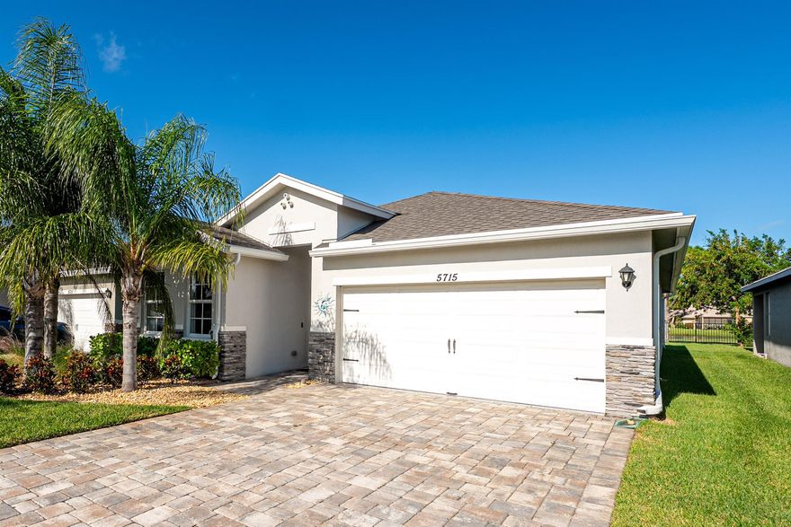 Built in 2020, this gated community home offers 3 beds, 2 baths, plus a flex room with a door that functions as a 4th bedroom and fits a king bed. The open concept split floor plan features wood-look tile, and a spacious owner's suite with lake and golf course views. Enjoy a covered lanai with an electric phantom screen, plus hurricane impact windows and doors. The 2-car garage includes epoxy flooring and a pulley storage system.  Smart-home features, a custom built in electric fireplace, upgraded washer and dryer, and Low HOA with a community pool, minutes to Hobe Sound Beach, and not in a flood zone!