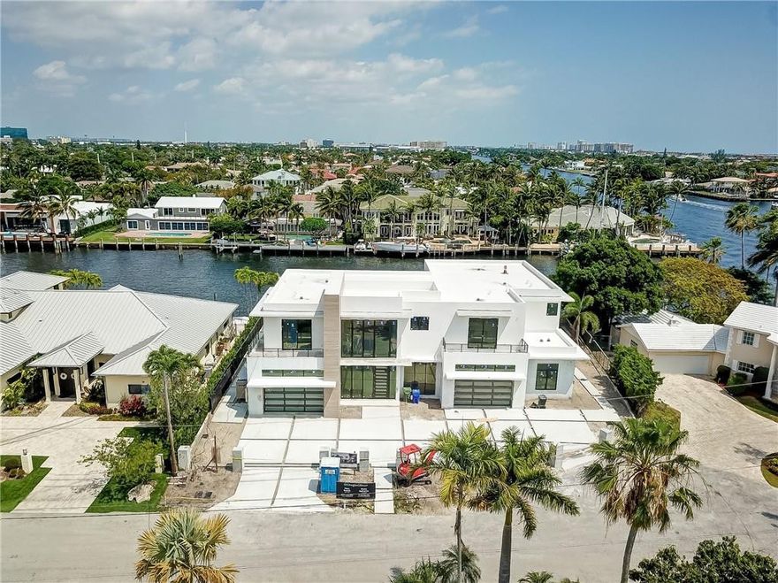 This magnificent new construction home is situated one lot from the intracoastal waterway and on the widest canal in Coral Ridge Estates, with 125 feet of water frontage. Built with no expense spared, this masterpiece features: 2 master suites, two 2 car garages, an open/flow through floor plan downstairs and water views from almost everywhere in the house.  Located across the street from Coral Ridge Country Club and built of the highest quality, this property will blow you away.