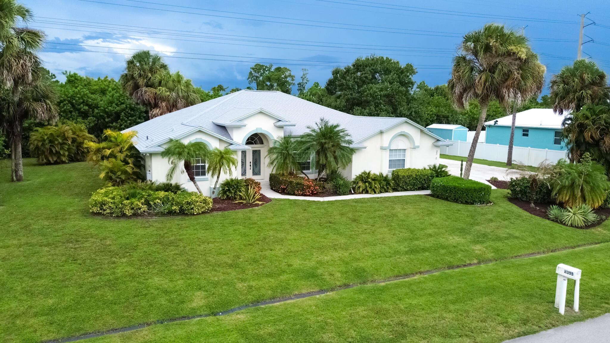 Built in 2002, this solid CBS home sits on a rare oversized .48-acre lot with plenty of room for all your toys! Featuring 3 bedrooms, 2 baths, and a 2-car garage with an extended driveway, it's perfect for boaters or RVs--complete with an RV hook-up. Enjoy peace of mind with a NEW roof (2024), AC (2019), and water heater (2022). Inside, a spacious split open floor plan with cathedral ceilings flows to a covered, screened lanai overlooking private preserve views. The master suite offers dual walk-in closets, a Roman tub, walk-in shower, and dual sinks. Freshly painted and move-in ready, this home blends comfort and convenience with nearby Tradition, shopping, dining, highways, and medical facilities.