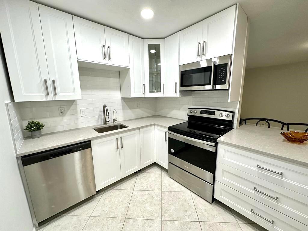 Beautifully Renovated 2-Bedroom, 2-Bath Condo in Active Adult CommunityStep into this light and bright second-floor unit, completely renovated for modern comfort. Featuring impact-resistant windows and sliding doors, upgraded lighting, and no popcorn ceilings, this home offers both style and peace of mind.The remodeled kitchen boasts upgraded cabinets, a sleek tile backsplash, and quartz countertops. Both bathrooms have been tastefully updated with newer vanities and elegant porcelain tile.Enjoy a spacious balcony overlooking a serene garden view. The building includes an elevator for added convenience.This home is ideally situated near major roads, medical centers, shopping, dining, and just a short drive to the beach and Atlantic Avenue.