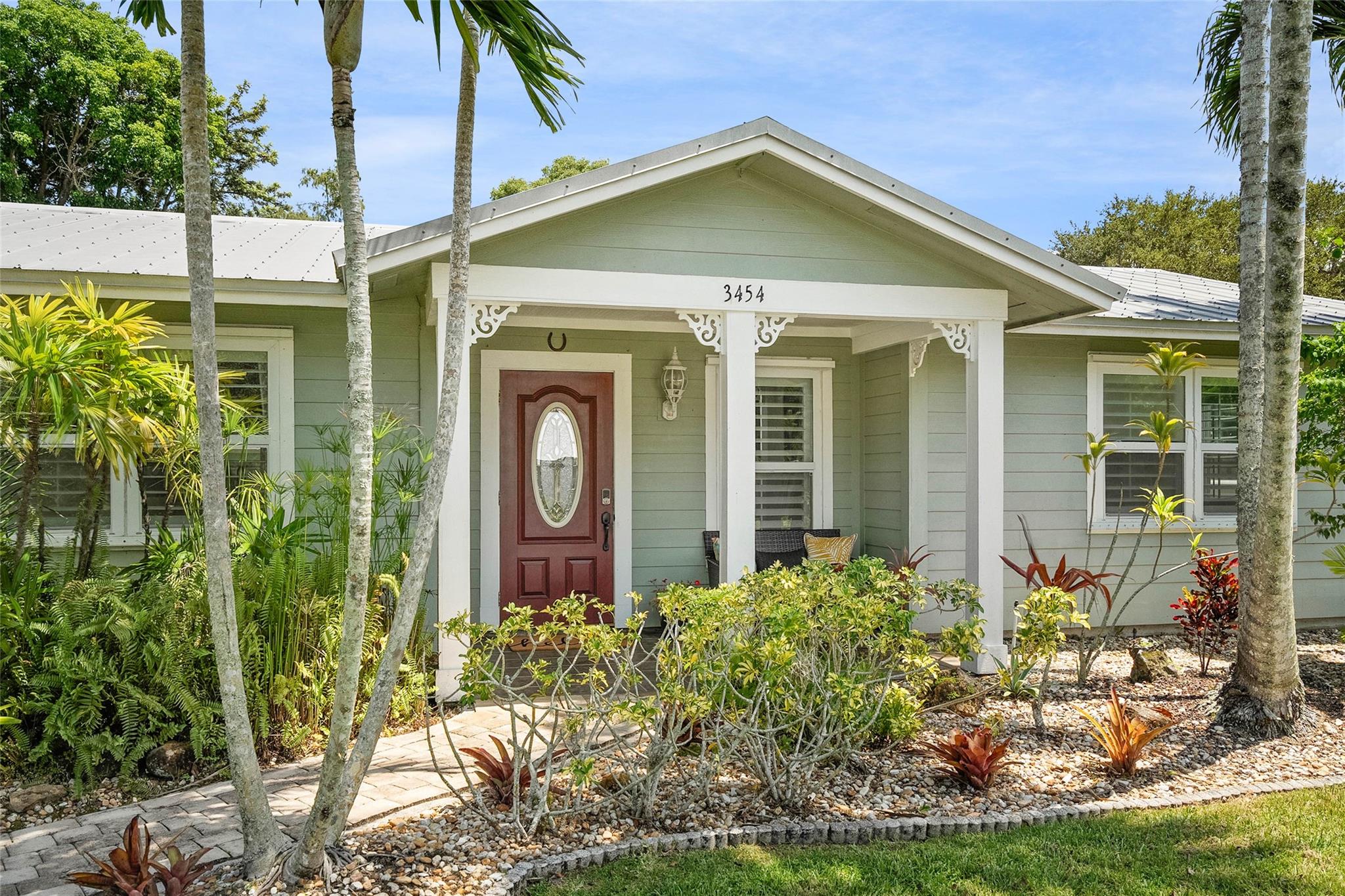 Spacious & Versatile; this beautifully remodeled 4BD/3BA features an open-concept layout ideal for entertaining and multi-generational living. Two private primary suites offer flexibility—one with its own secluded patio. Enjoy the large screened-in patio with built-in BBQ and outdoor kitchen—perfect for Florida living! Unwind in the private hot tub surrounded by lush tropical landscaping. Additional features include a 2-car garage and gated boat/RV parking. Located in Port Sewall Harbor & Tennis Club, enjoy community amenities like a pool, tennis, pickleball, and basketball—all with a Low HOA fee. Just minutes to beaches, boat ramp at Sandsprit Park, Sailfish Sands Golf Course, Iconic Banyan Tree Tunnel, Port Salerno Waterfront District, and Downtown Stuart.