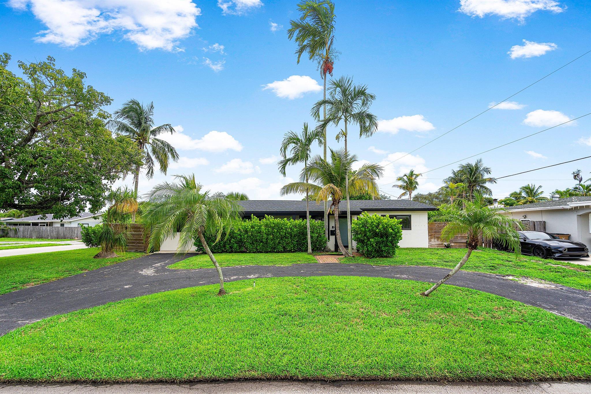 Welcome to this ultra-modern 4BR/2BA home on a fully fenced corner lot in east Deerfield Beach. The oversized yard with BBQ area is ideal for entertaining and has room for a pool. Inside, enjoy high-end renovations throughout: large-format tile floors, LED lighting, quartz kitchen with white shaker cabinets, stainless appliances, and matte black fixtures. Designer bathrooms feature custom vanities, wall tile, and fixtures. Major updates include 2022 roof, full impact glass windows/doors, new underground plumbing, and a tankless water heater. Minutes to shopping, dining, and the beach, this turnkey home offers style, comfort, and peace of mind.