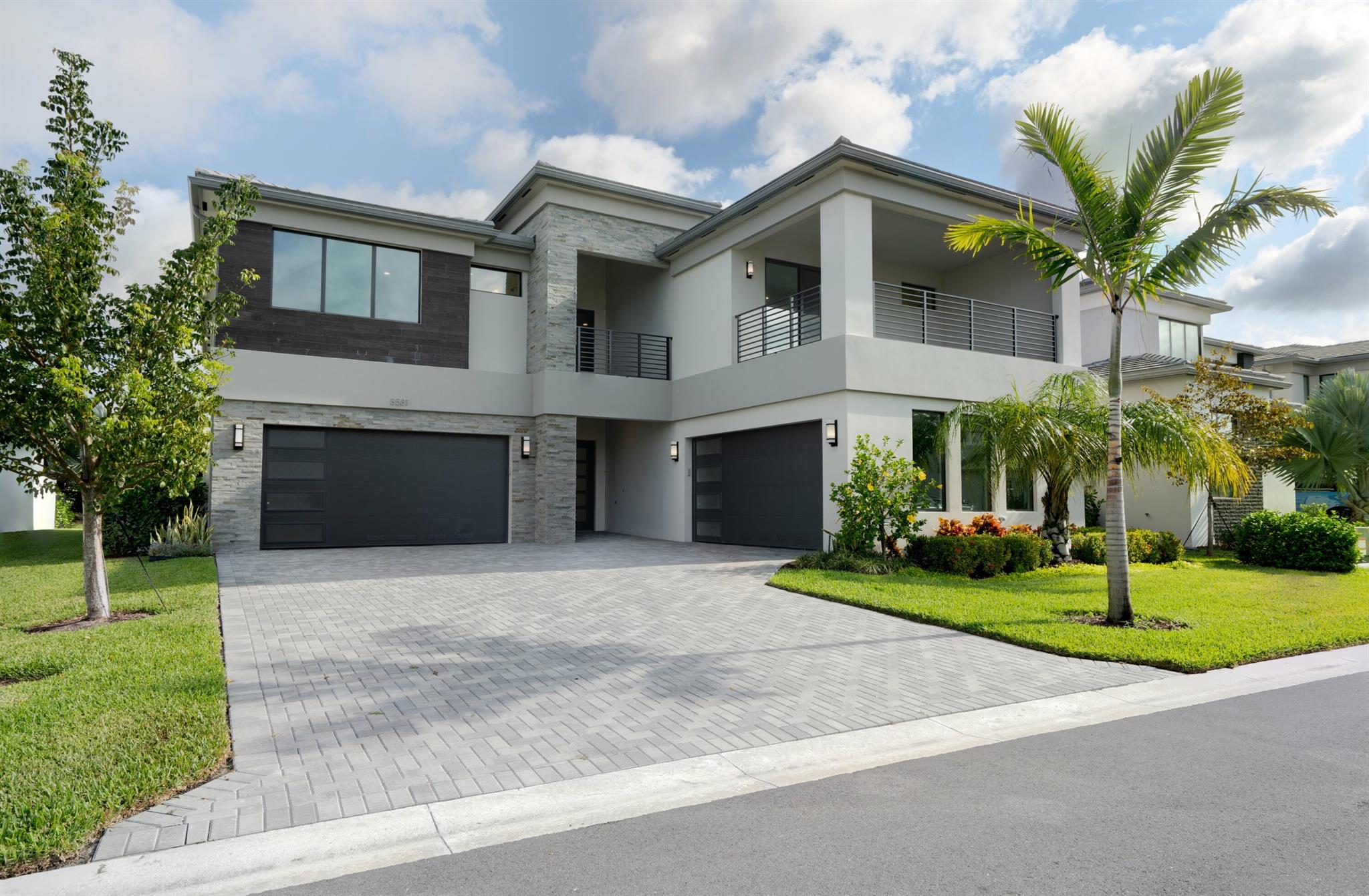 This new two-story contemporary gem at Lotus Palm, Boca Raton, delivers an elevated resort lifestyle. An open floor plan great room provides ease for living and entertainment, the great room and kitchen are easily assessable to the formal dining room, den and game room. The first-floor guest bedroom is perfect for visiting family and guests, and the upstairs bedrooms are served by a loft and media room.