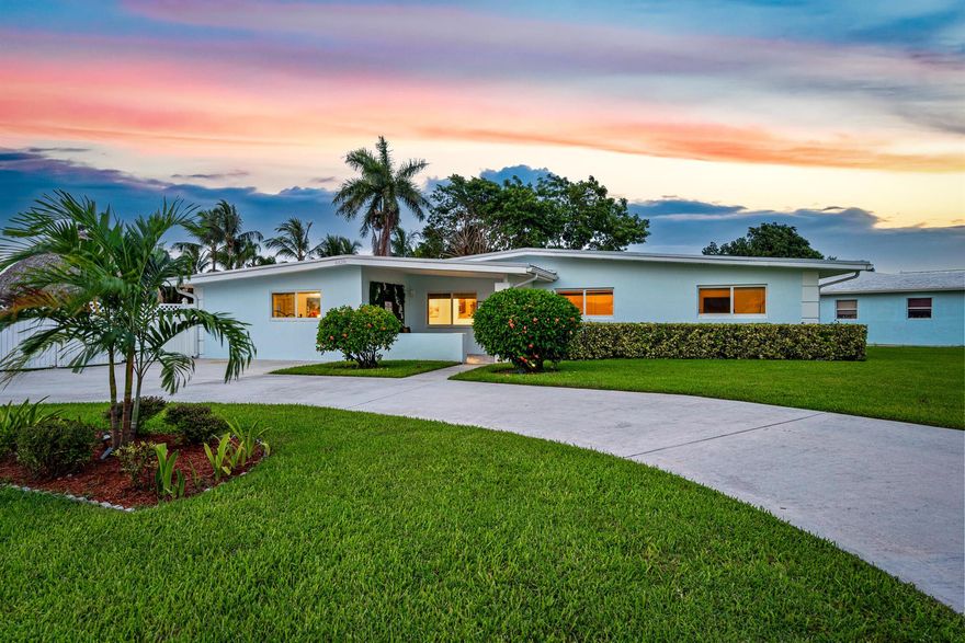 Discover this stunning waterfront 4bd 3bth short-term rental pacing to generate over $120,000 in its first year and more than $50k in future reservations already secured. Recently renovated, it features a heated saltwater pool, tiki hut, custom putting green, covered patio, concrete pad for your boat or RV, 150-foot seawall, dock, impact windows and doors, crown molding, and a newer metal roof. With negotiable furniture, a perfect 5-star rating on Airbnb and VRBO, and prime location minutes from I-95, Downtown WPB, beaches, shopping, and dining, this is a turnkey investment you don't want to miss!