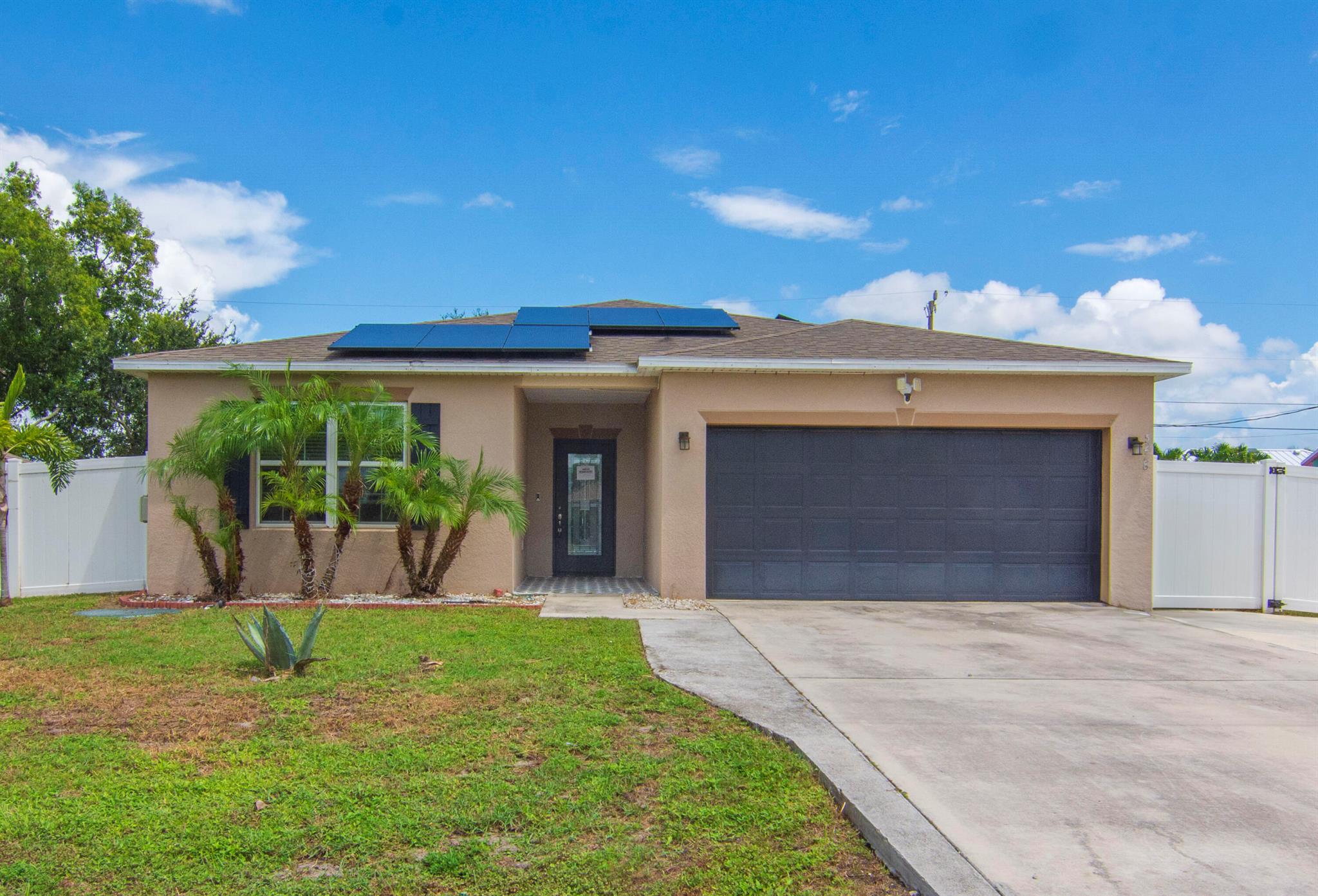Discover this spacious 2019 Maronda-built home offering 1,874 sq ft of living space in a north Port St. Lucie location!This beautifully maintained CBS home features tile flooring throughout and a split floor plan ideal for privacy and functionality. The island kitchen is a chef's dream, complete with upgraded lighting, pantry, and a decorative fireplace wall that adds a stylish focal point to the main living area.The expansive dining room is perfect for entertaining and hosting family gatherings. The primary suite boasts a custom walk-in closet for added storage and convenience. Enjoy outdoor living with a rear pergola, two storage sheds, and low-maintenance PVC fencing.Additional features include a 2-bedroom garage conversion (ideal for guests, extended family, or flexible