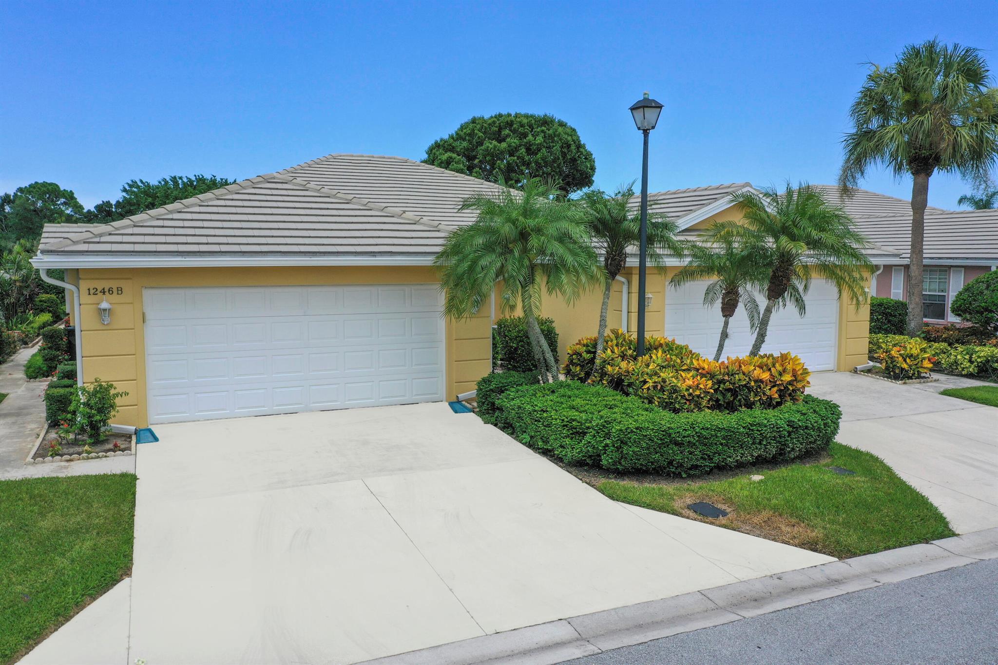 The location and view excel in this popular Lakes villa in St. Lucie West. Both bedrooms are ensuite in this water view villa. Ther is plenty of outside space to enjoy the Lake view with both a large, covered porch and open screened area. This expanded Capri has extra room for an open den or Florida room. The kitchen has granite and newer SS appliances. There is crown molding and laminate or tile throughout. The AC, WH and plumbing were replaced in 2021 and the roof in 2012. The living area has a gorgeous built-in with mirrors, perfect for a big TV and extra storage. The location within the convenient Lakes is very private and is lushly landscaped at the end of the street. Enjoy the low HOA fee and hurricane shutters in a villa close to everything St. Lucie West has to offer.