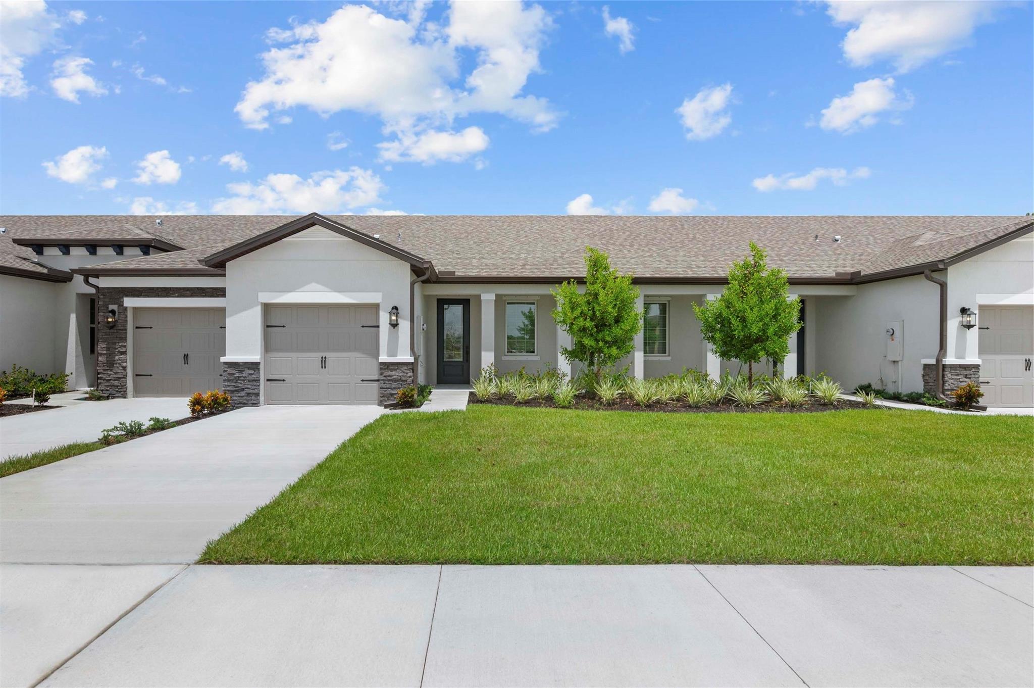 Ask us about our incentives, builder paid closing cost, and more! The stunning Carlo is located within the family-friendly community of Celebration Pointe. This one-story home features an open floor plan, 2 bedrooms and 2 full baths complete with upgrades including stainless-steel Whirlpool® appliances, quartz kitchen countertops with an island, beautiful 42” white-wood cabinets with crown molding and an attached garage. The Carlo consists of a master suite complete with a spacious walk-in closet. Additional highlights include a laundry room, a covered front porch and front yard landscaping. Celebration Pointe offers residents numerous amenities including a pool, walking paths and a future community clubhouse all in a premier location.