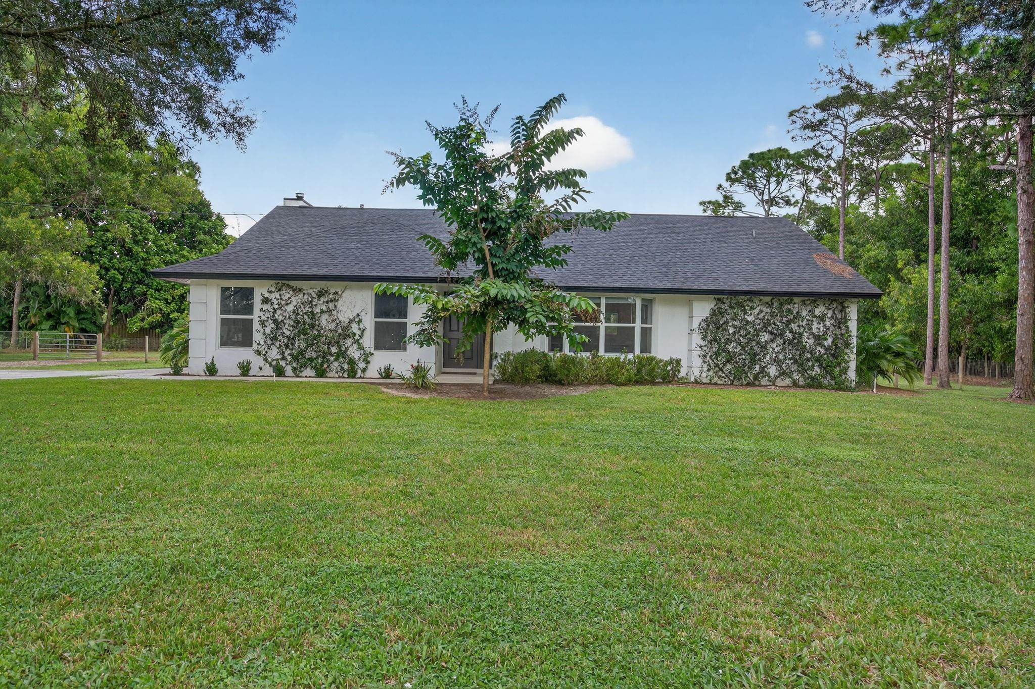 Renovated Jupiter Farms CBS 3/2/2 pool home! Located on a quiet dead-end paved road (no thru traffic). 1.15 acres with 2022 roof. Luxury vinyl flooring throughout with shaker-style doors, kitchen featuring new 42’’ upper cabinets, quartz countertops, and stainless steel appliances including wine fridge. Both bathrooms feature new tile throughout, vanities, millwork, and lighting. All new light fixtures/fans and baseboard throughout. Impact garage door & patio sliders. The pool patio features gorgeous stained/sealed tongue and groove ceiling & cabana guest bath access.
