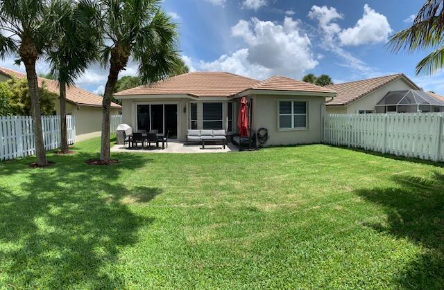 Beautiful 3 bedrooms and 2 baths with 2 car garages totally updated with a large fenced backyard, a newer roof, newer appliances with and extra refrigerator in the garage.This spacious split floorplan features a living room, dining area and a center island with a teppanyaki grill and a snack bar. Chef's kitchen features classic white cabinets, granite countertops, a tiled backsplash, high hat lighting. Large master retreat with a walk-in closet, double sinks, a soaking tub and a walk-in shower. Relax on the patio overlooking the large, fenced yard with tropical landscaping. Neutral tile on the diagonal, crown molding and surveillance equipment with cameras are just a few of the highlights in this split floorplan home. WATER & Basic Cable are Included. Accordian Shutters. Lanscaping is ten