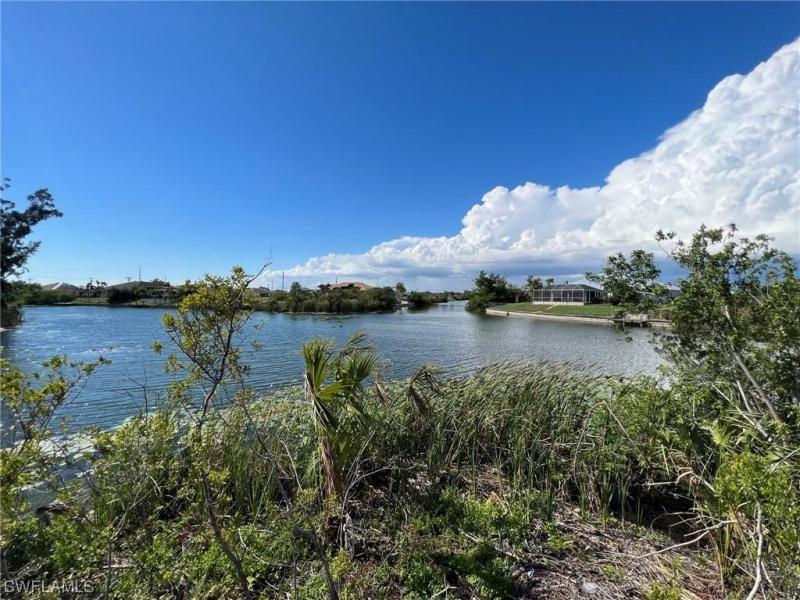 Beautiful, oversized lot at an intersecting canal with over 220 linear feet of water frontage. This lot has been mostly cleared at the end of street with a buffer to keep green space between you and your neighbor. Great price for an amazing lot on an intersecting Canal. Great mix of new construction homes and established homesites in the neighborhood. Close to schools, parks and a short distance to major roadways going into Ft Myers and Punta Gorda. Great investment as the neighborhood continues to grow! Hurry this won't last!