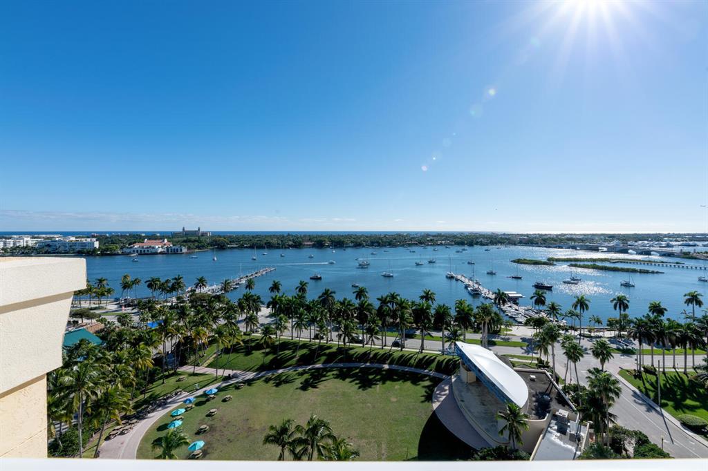 Stunning views from this masterfully renovated 11th floor unit. Private elevator lobby opens directly into the unit. Front section includes a central kitchen, flanked by two living areas and a dining area, in a large open concept space. Balcony overlooking intracoastal, ocean, The Breakers and both in-town bridges to Palm Beach Island. Master suite has same water views and incredible sunrises, dual walk-in closets with built-ins. Rear of the unit includes a central powder room, two storage rooms, laundry room and guest bedroom with en-suite bath, large walk-in closet and its own balcony facing west. Building features rooftop pool, club room, fitness center, yoga studio, valet parking, secure garage parking and 24 hour lobby attendant.